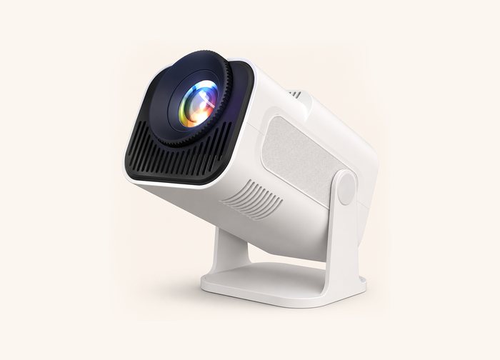 A white projector on a tilting stand, lens angled towards the viewer.
